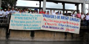 Aktivist*innen zeigen Protestplakate gegen Megaprojekte im Isthmus von Tehuantepec. Foto: Wolf-Dieter Vogel